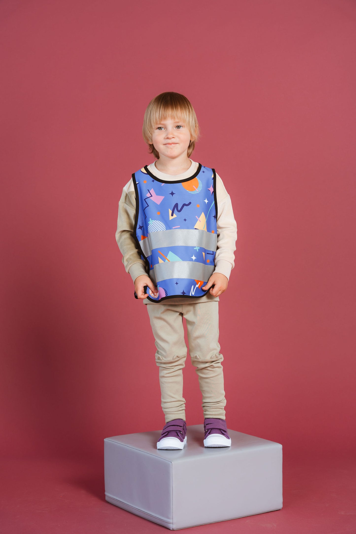 boy wearing purple colourful reflective safety vest for kids